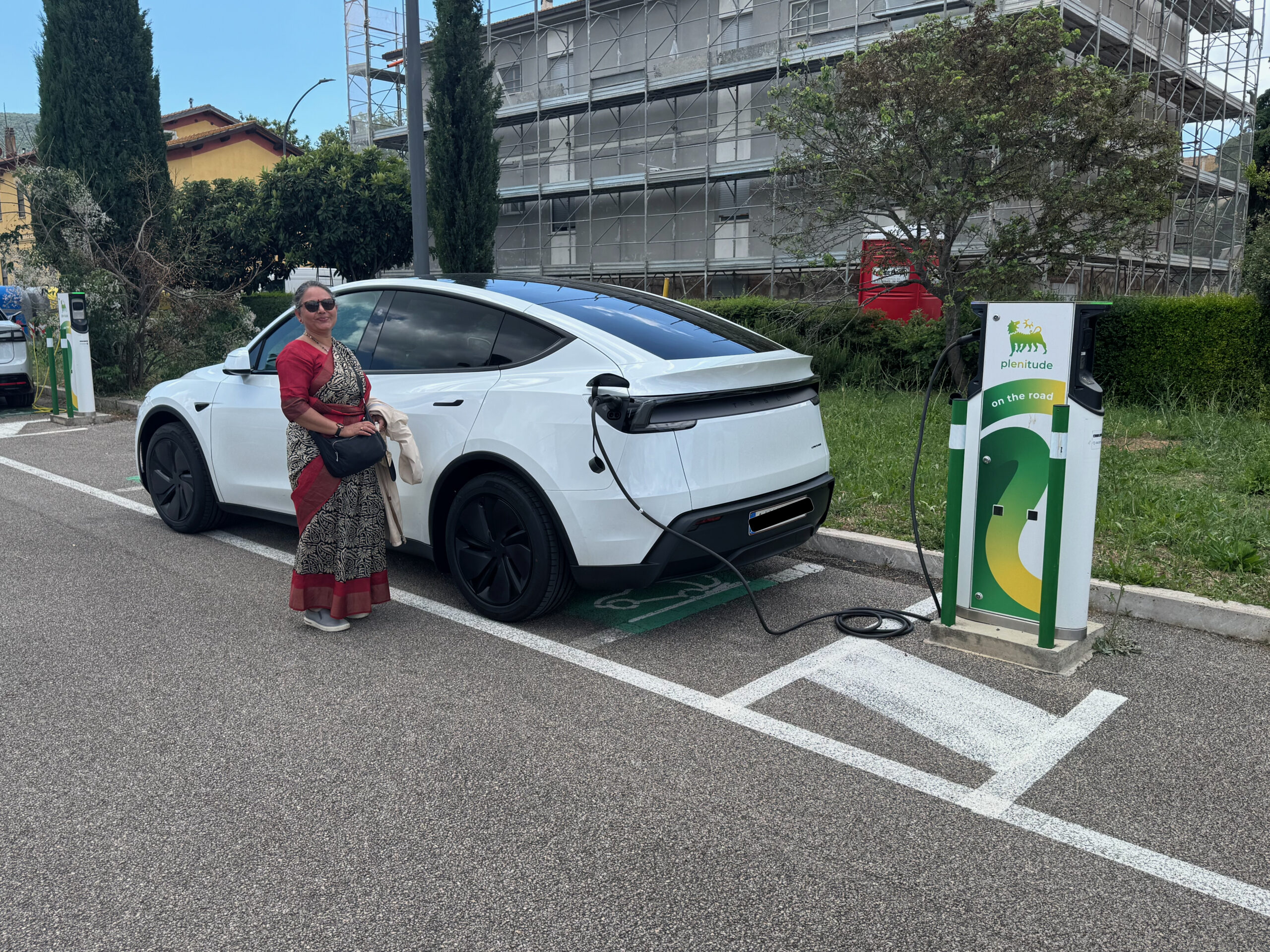 Kaberi with our car charging in the hamlet of Alberese, Grosseto, Italy